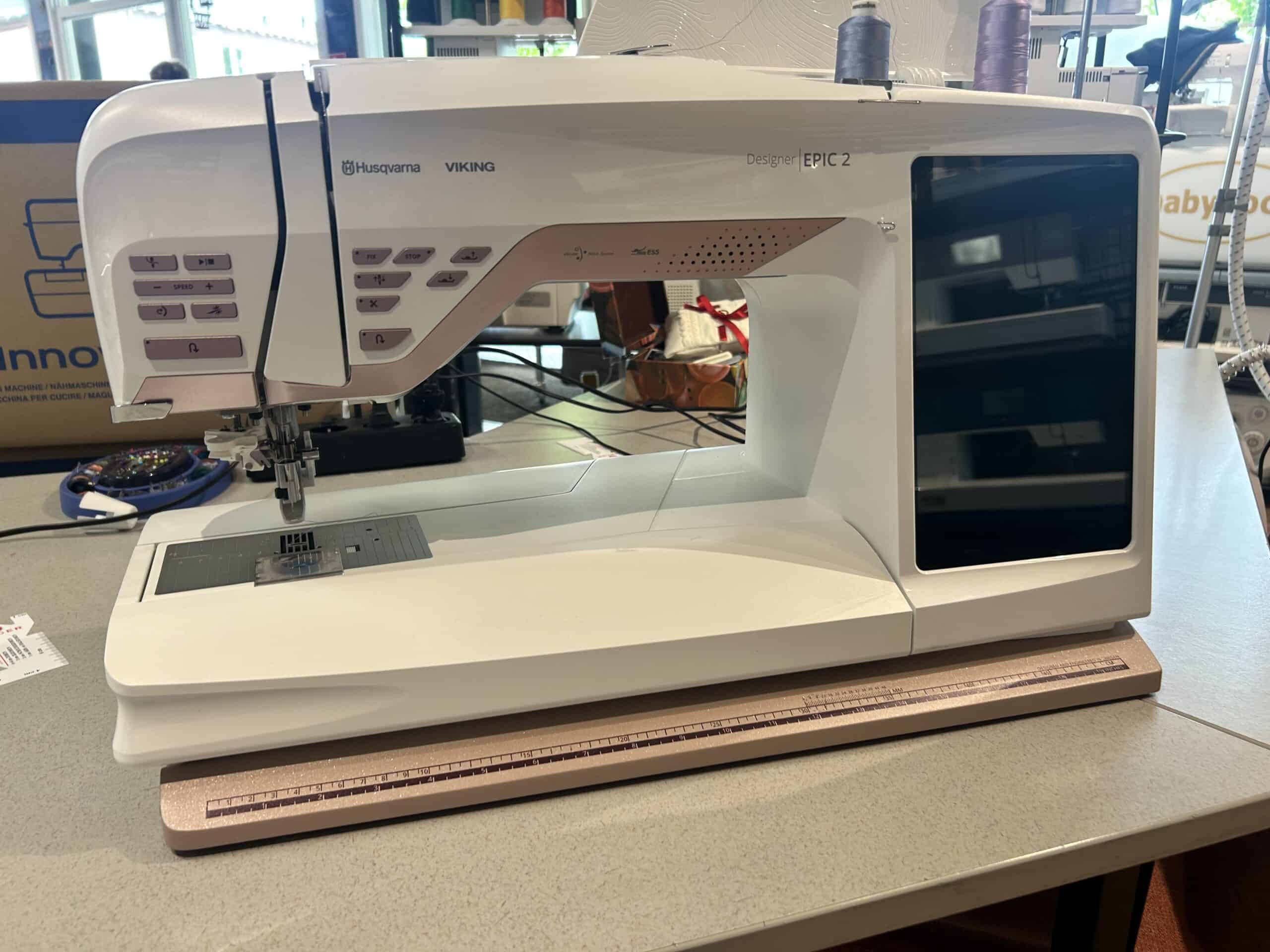 IMG_3684 - Eltink Naaimachines Husqvarna Viking Epic 2 sewing machine on a counter with a brown ruler in front and fabric kept to the side.