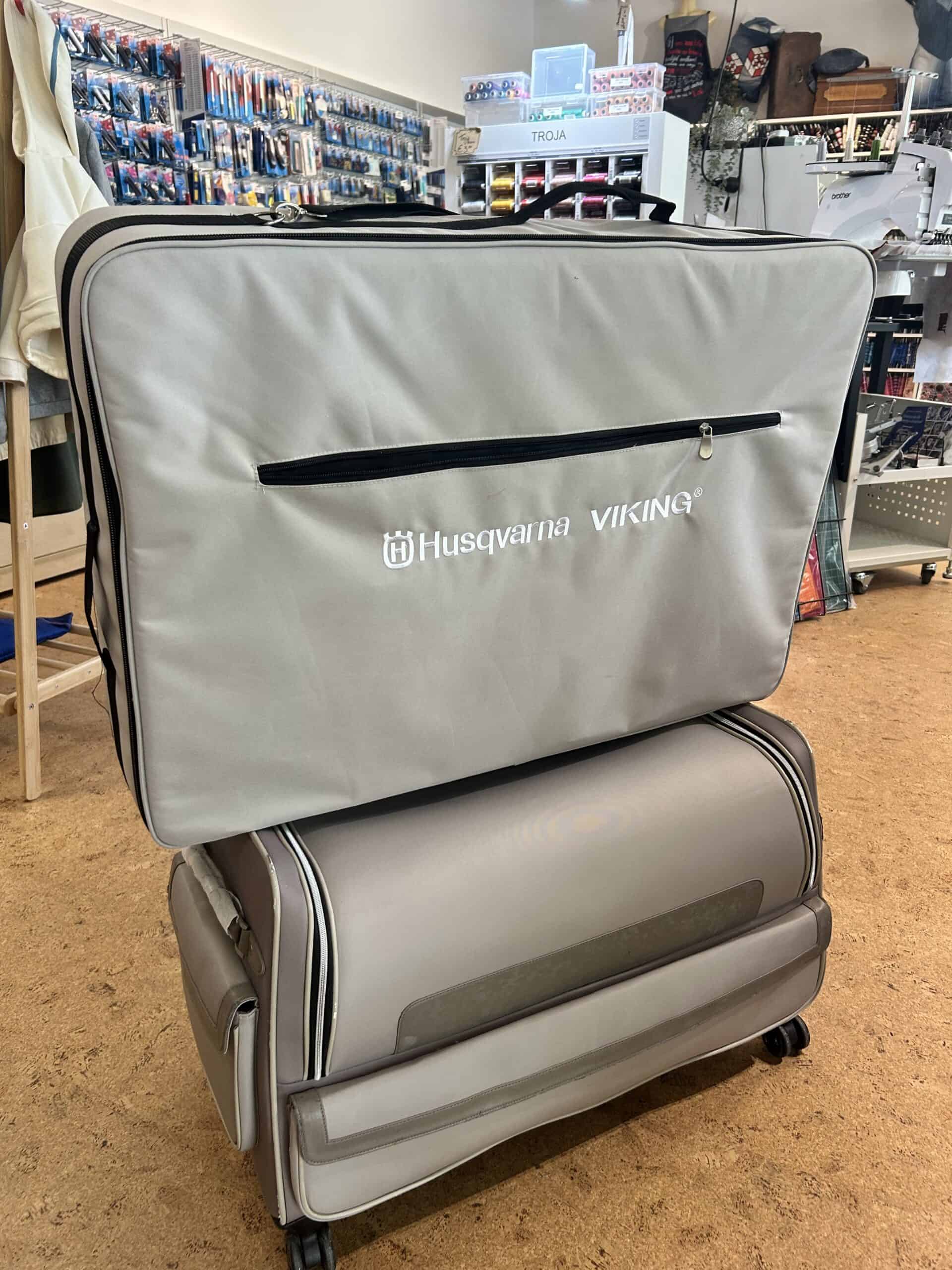 IMG_3686 - Eltink Naaimachines Large gray Husqvarna Viking sewing machine case on a wheeled cart in a sewing shop.