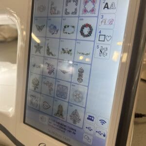 Touchscreen interface showing 24 embroidery pattern thumbnails numbered 001–024 with a side panel of icons (font, notes, etc.).