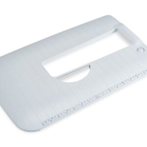 White desktop paper trimmer with a cutting slot and built-in ruler, viewed from above, used to cut sheets of paper neatly.