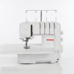 White Bernina L 820 overlock sewing machine with four thread spools and threading posts, shown from the side on a white background.
