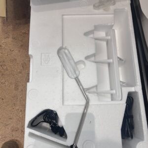 White foam packaging with a metal rod and plastic mounting pieces inside, near a cardboard box labeled Model BLETS8