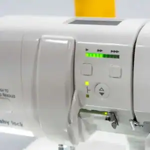 White sewing machine control panel with LED indicators and navigation buttons; shows stitch/length controls and thread needle button labeled 'Push to Thread Needle'.